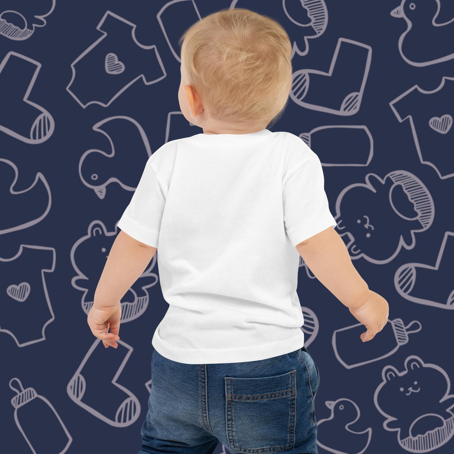 Back view of a baby wearing a funny, white Born Brash t-shirt with a blue patterned background featuring baby toys, funny baby clothing, and baby bottles. Ideal for showcasing baby shirt fit and quality.