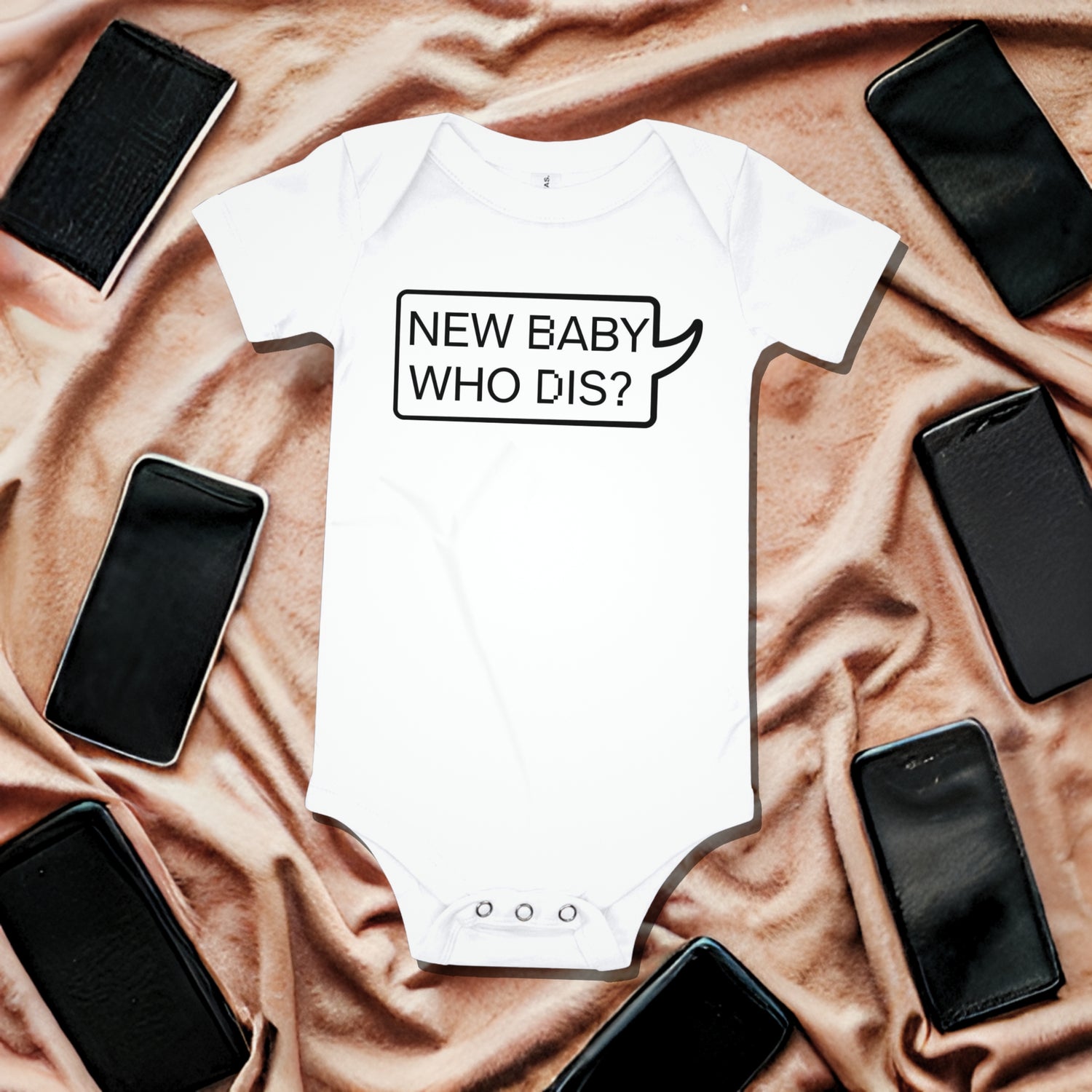 White baby bodysuit with "NEW BABY WHO DIS?" text in a speech bubble outline, on reddish-brown draped fabric surrounded by smartphone illustrations. A funny humorous baby clothes design playing on a modern phrase for a new arrival or baby shower gift from Born Brash.