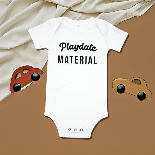 White baby bodysuit with "Playdate MATERIAL" text on a two-toned background with toy car illustrations. A funny humorous and relatable baby clothes design perfect for playdates from Born Brash.