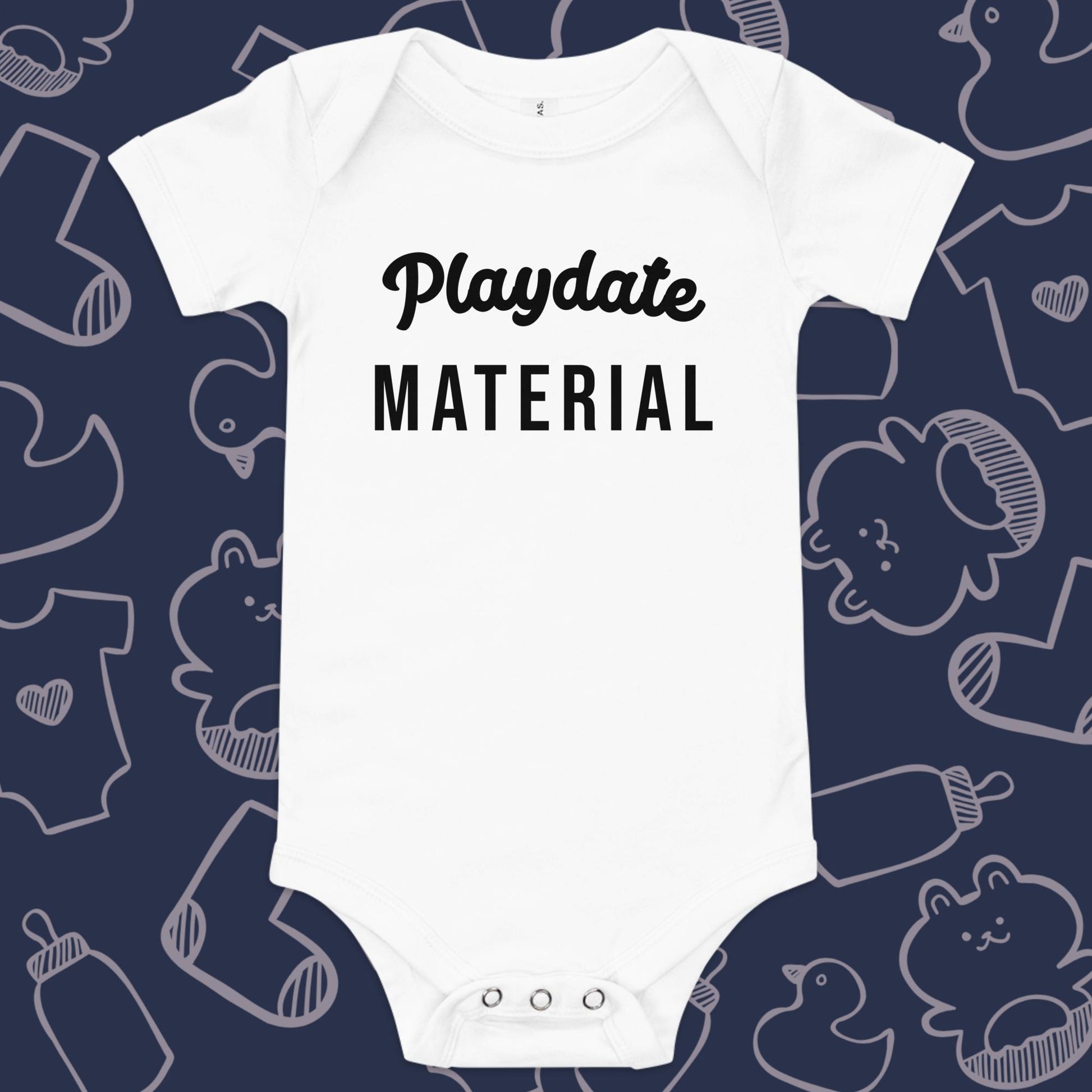 Funny, white baby onesie featuring the playful text "PLAYDATE MATERIAL" against a whimsical, blue backdrop of ducks, socks, stuffed animals, baby bodysuits, and bottles