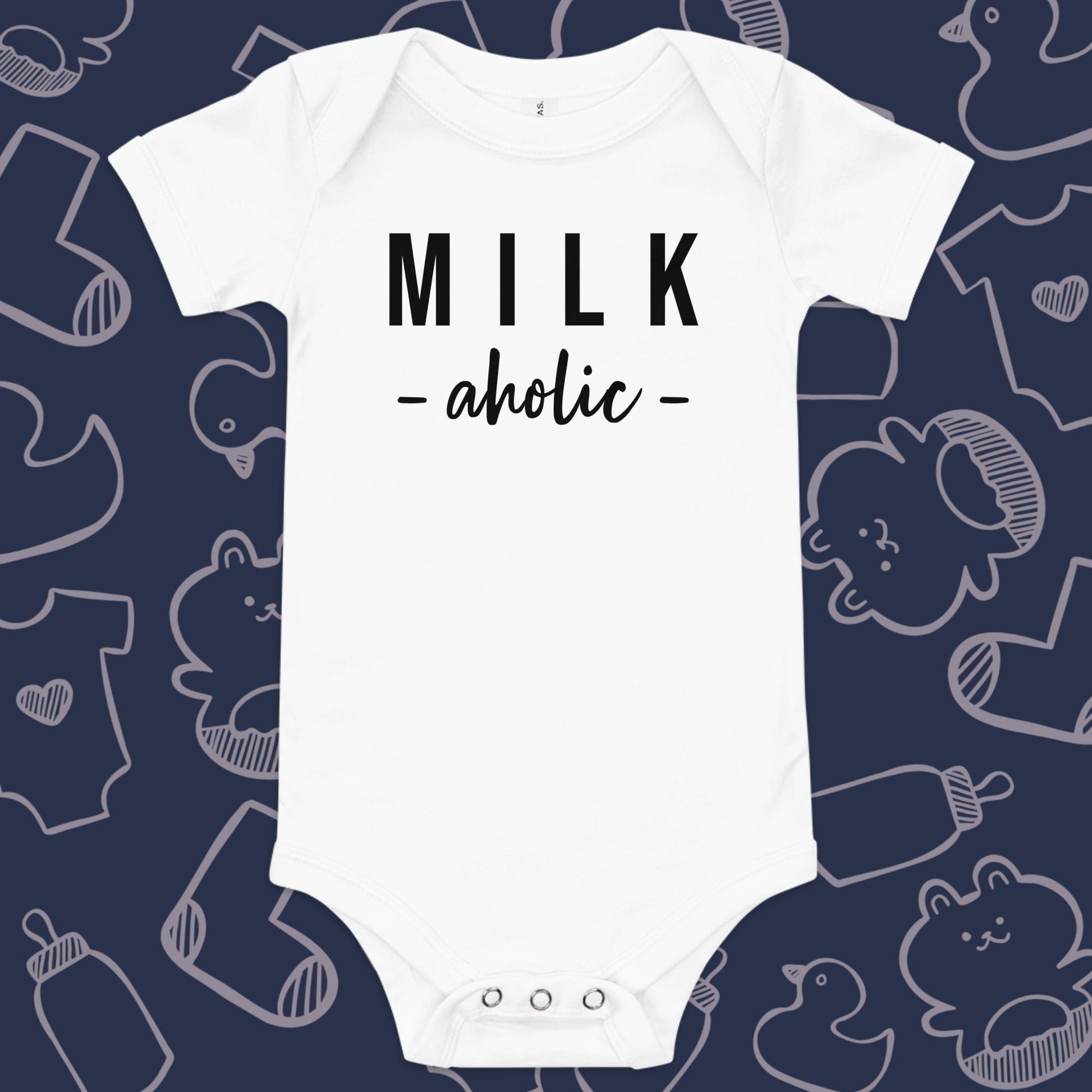 Funny, white baby onesie featuring the playful text "MILK AHOLIC" against a whimsical, blue backdrop of ducks, socks, stuffed animals, baby bodysuits, and bottles
