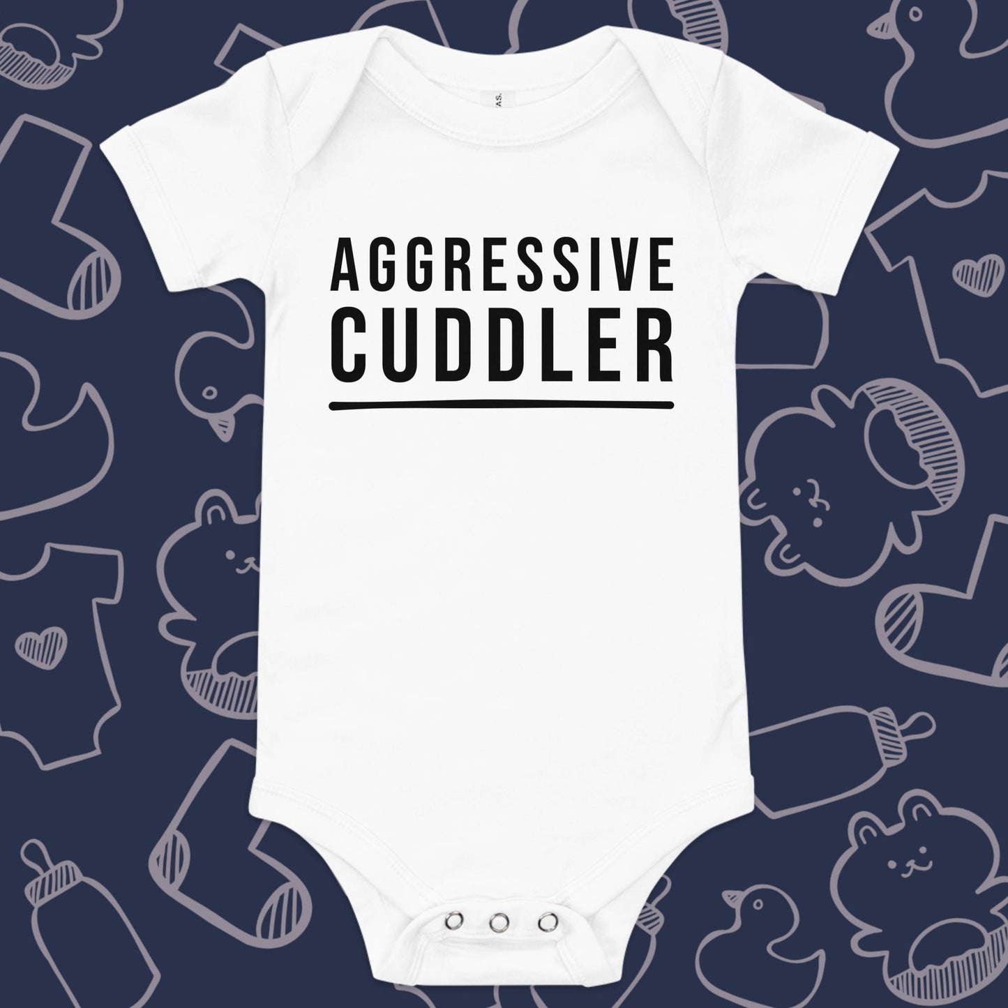 Funny, white baby onesie featuring the playful text "AGGRESSIVE CUDDLER" against a whimsical, blue backdrop of ducks, socks, stuffed animals, baby bodysuits, and bottles