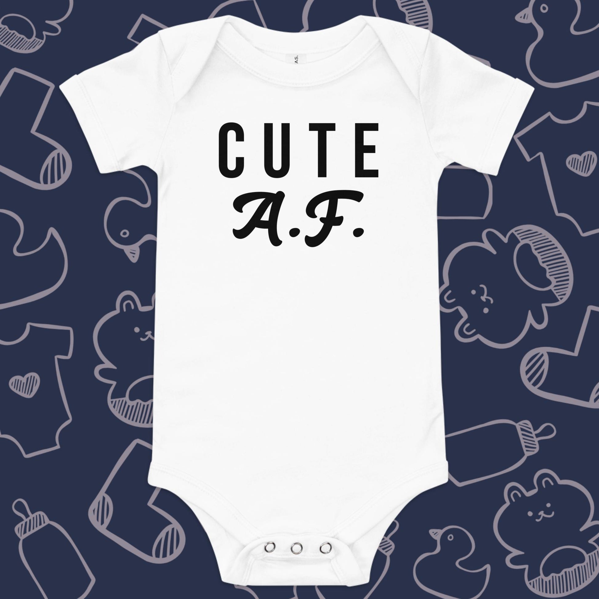 Funny, white baby onesie featuring the playful text "CUTE AF" against a whimsical, blue backdrop of ducks, socks, stuffed animals, baby bodysuits, and bottles