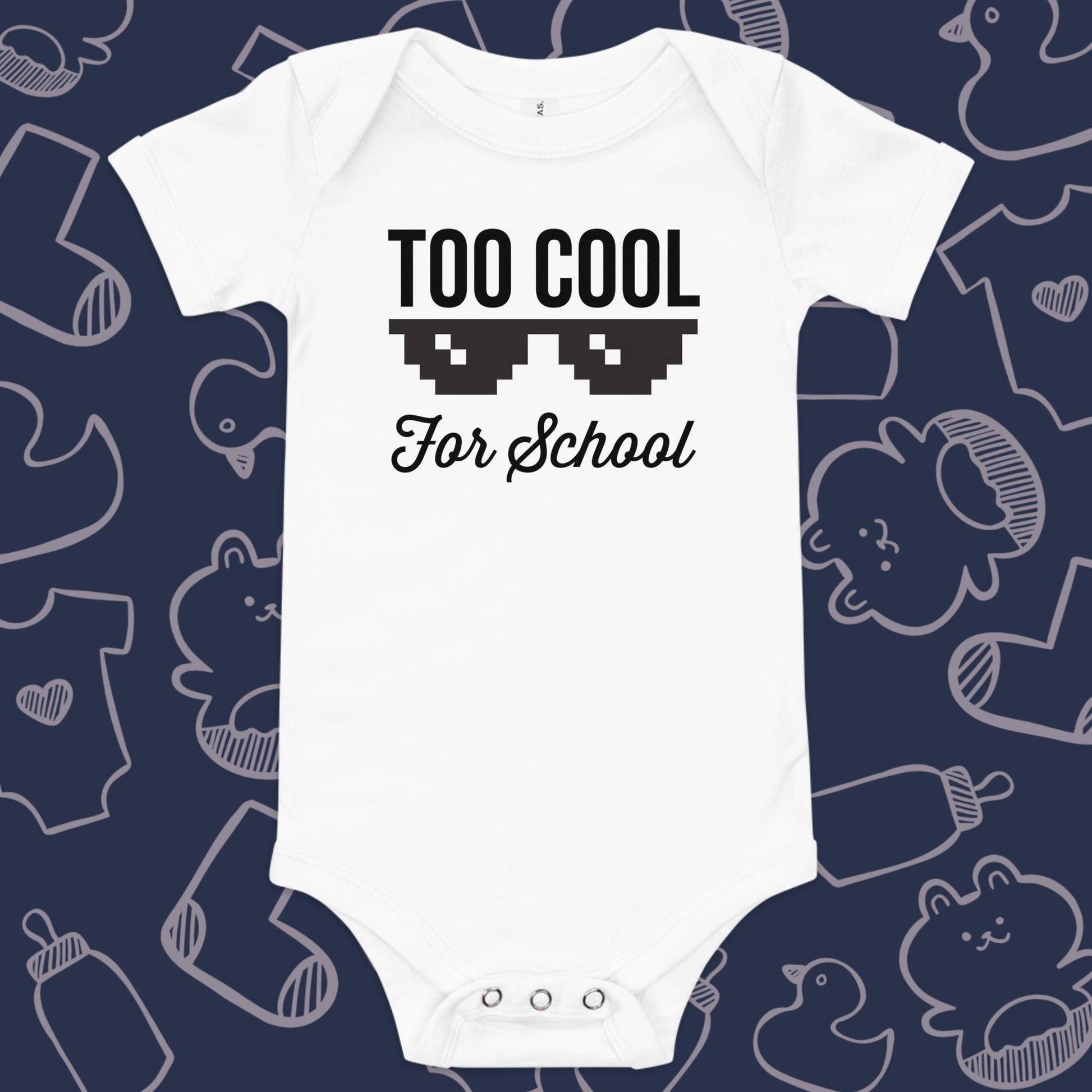 Funny, white baby onesie featuring pixellated sunglasses and the playful text "TOO COOL FOR SCHOOL" against a whimsical, blue backdrop of ducks, socks, stuffed animals, baby bodysuits, and bottles