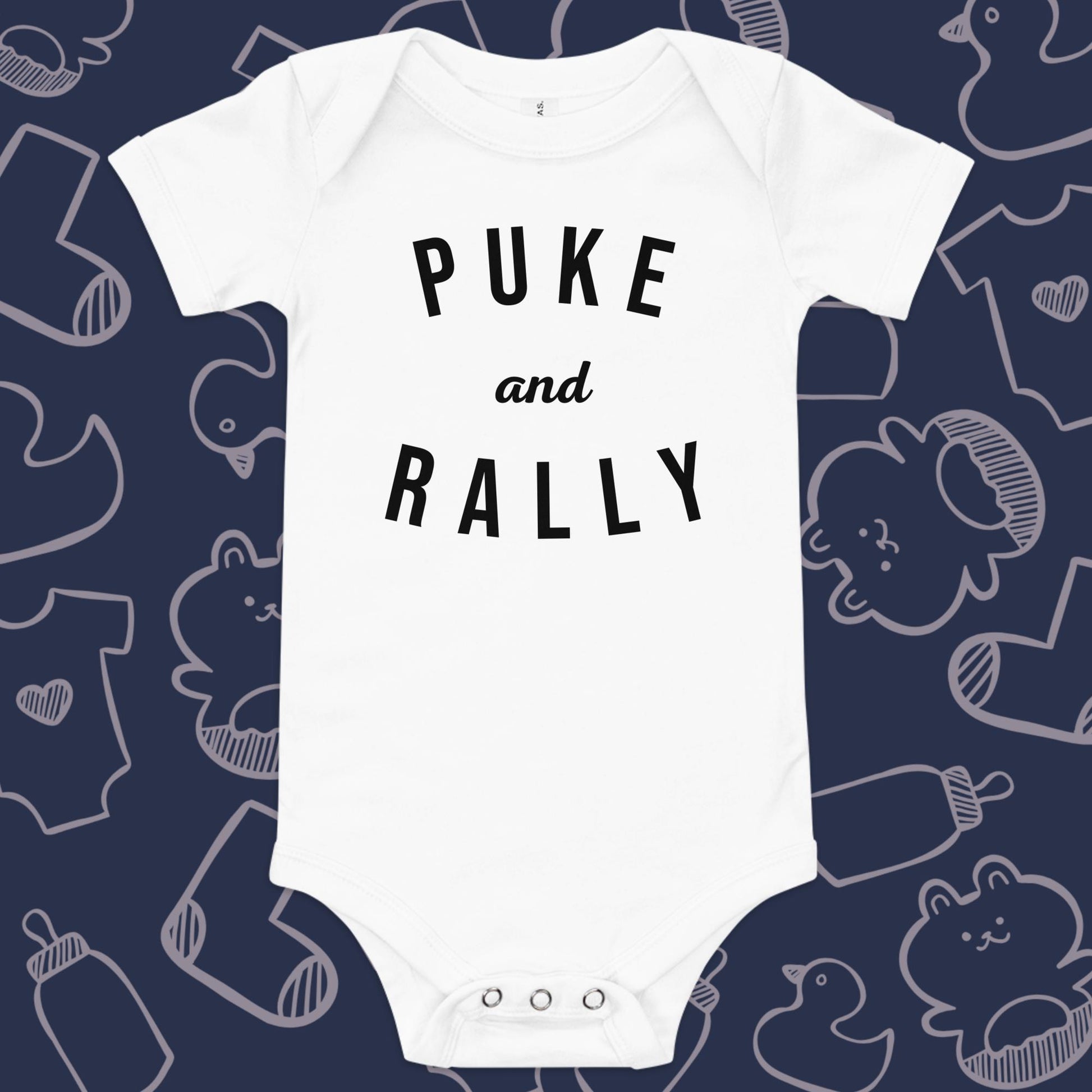 Funny, white baby onesie featuring the playful text "PUKE AND RALLY" against a whimsical, blue backdrop of ducks, socks, stuffed animals, baby bodysuits, and bottles