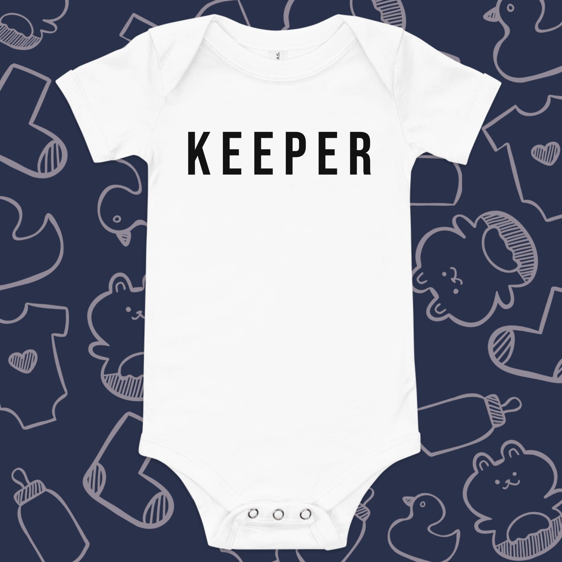 Funny, white baby onesie featuring the playful text "KEEPER" against a whimsical, blue backdrop of ducks, socks, stuffed animals, baby bodysuits, and bottles