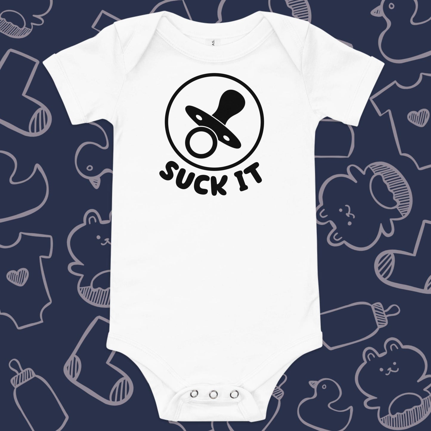 Funny, white baby onesie featuring an image of a pacifier and the playful text "SUCK IT" against a whimsical, blue backdrop of ducks, socks, stuffed animals, baby bodysuits, and bottles