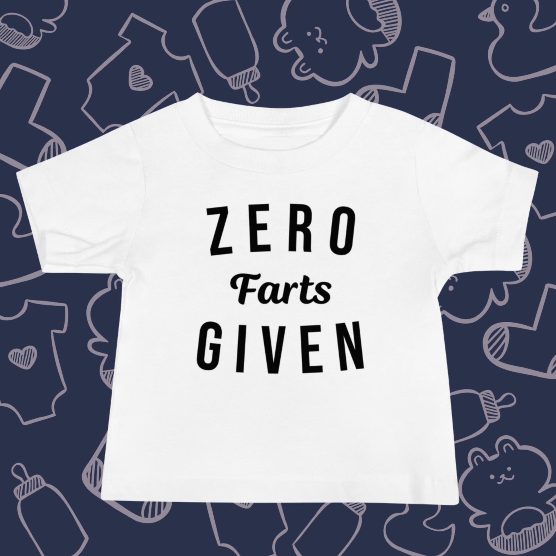 Funny, white baby t-shirt featuring the playful text "ZERO FARTS GIVEN" against a whimsical, blue backdrop of ducks, socks, stuffed animals, baby bodysuits, and bottles