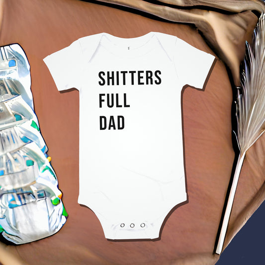 White baby bodysuit with "SHITTERS FULL DAD" text next to a stack of diapers and feathery stalk. A funny humorous baby clothes design referencing a classic movie, perfect as a new dad gift or funny baby shower gift from Born Brash.