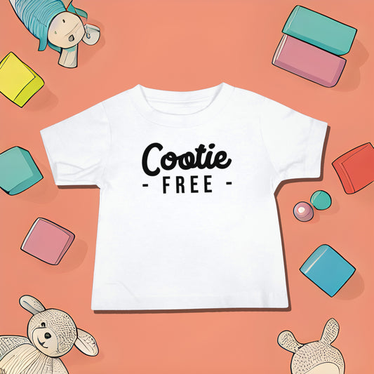 White baby t-shirt with "Cootie - FREE -" text on a reddish-orange background with toy illustrations. A funny humorous baby t-shirt design playing on the idea of cooties, making it a unique baby shower gift from Born Brash.