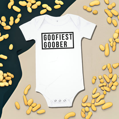 White baby bodysuit with "GOOFIEST GOOBER" text in a black box, surrounded by peanut illustrations. A funny humorous and quirky baby clothes design from Born Brash.