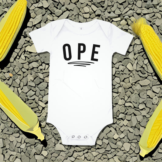 White baby bodysuit with "OPE" text underlined, on a gray textured background with corn illustrations. A funny humorous and relatable baby clothes design with regional charm from Born Brash.