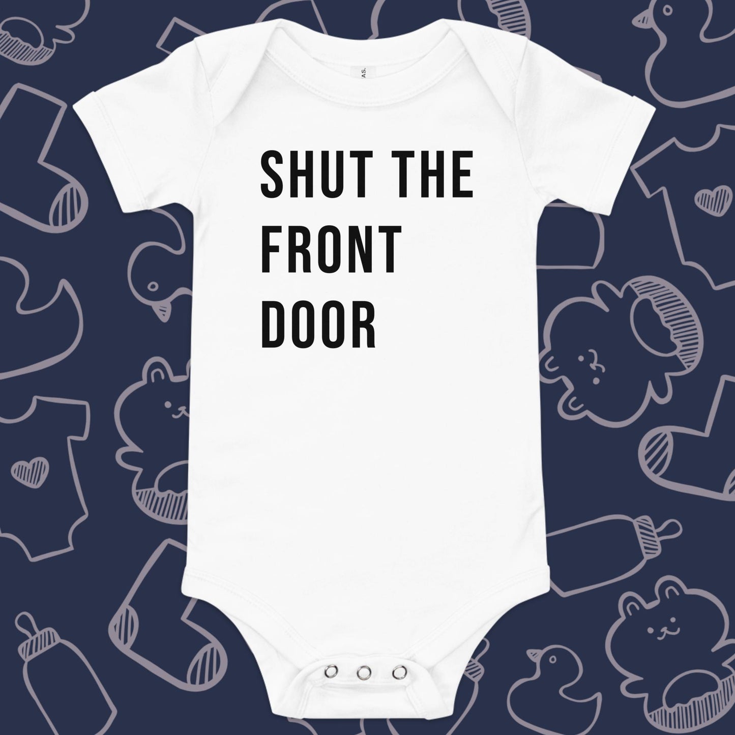 Funny, white baby onesie featuring the playful text "SHUT THE FRONT DOOR" against a whimsical, blue backdrop of ducks, socks, stuffed animals, baby bodysuits, and bottles