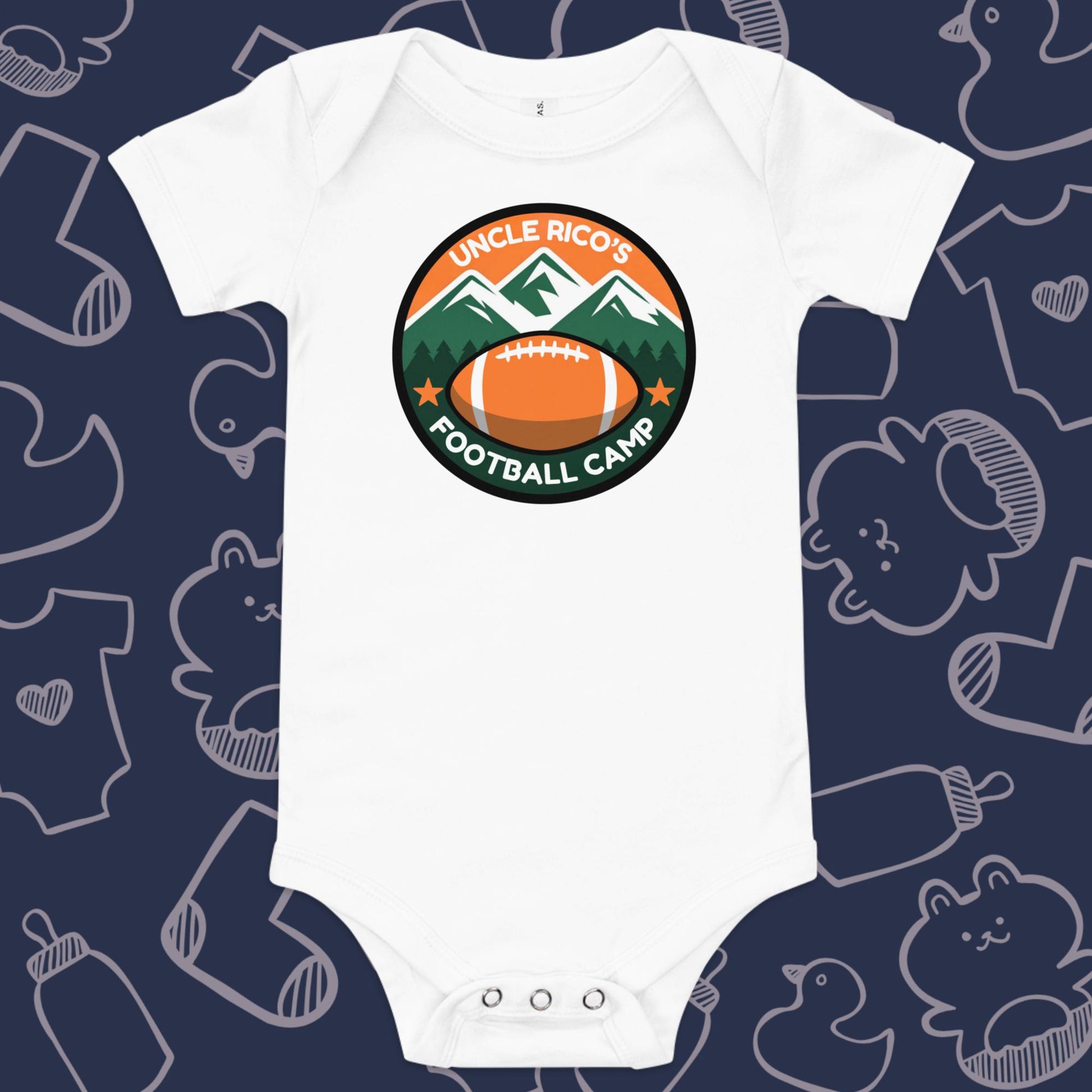 Funny, white baby bodysuit featuring the playful text "Uncle Rico's Football Camp" within a picture of mountains and a football against a whimsical, blue backdrop of baby toys, bodysuits, and bottles.