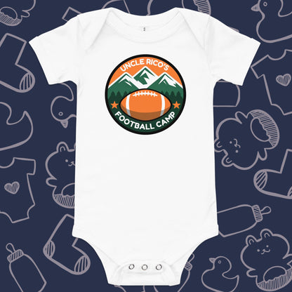 Funny, white baby bodysuit featuring the playful text "Uncle Rico's Football Camp" within a picture of mountains and a football against a whimsical, blue backdrop of baby toys, bodysuits, and bottles.