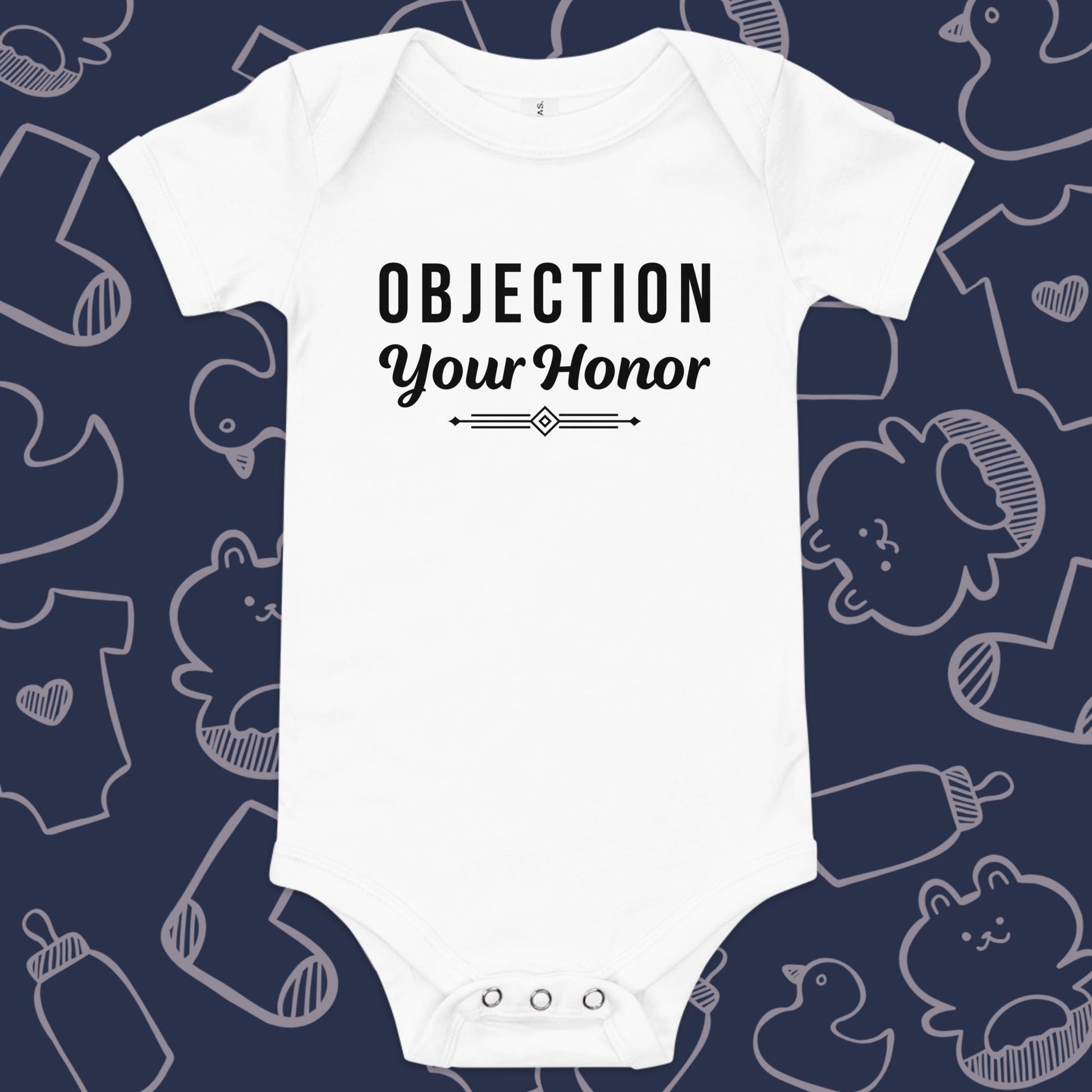 Funny, white baby bodysuit featuring the playful text "OBJECTION Your Honor" underlined against a whimsical, blue backdrop of baby toys, bodysuits, and bottles.