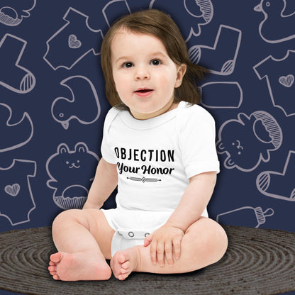 Baby wearing a funny white bodysuit with 'OBJECTION Your Honor' text against a blue background with baby clothing illustrations.